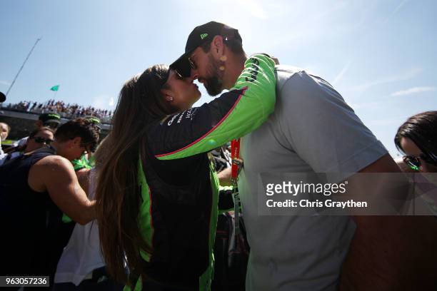 Danica Patrick, driver of the GoDaddy Chevrolet kisses Aaron Rodgers prior to the 102nd Running of the Indianapolis 500 at Indianapolis Motorspeedway...