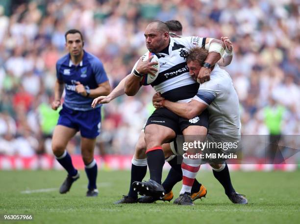 Barbarians' John Afoa is tackled by England's Chris Robshaw during the Quilter Cup match between England and the Barbarians at Twickenham Stadium on...