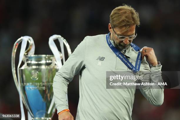 Dejected head coach manager Jurgen Klopp of Liverpool walks past the trophy with his losers medal during the UEFA Champions League final between Real...