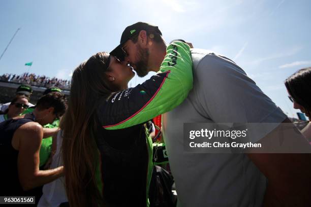 Danica Patrick, driver of the GoDaddy Chevrolet kisses Aaron Rodgers prior to the 102nd Running of the Indianapolis 500 at Indianapolis Motorspeedway...