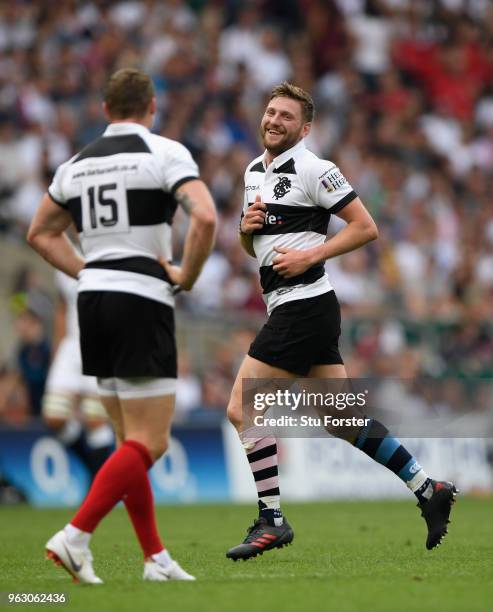 Barbarians player Finn Russell shares a joke with Chris Ashton during the Quilter match between England and Barbarians at Twickenham Stadium on May...