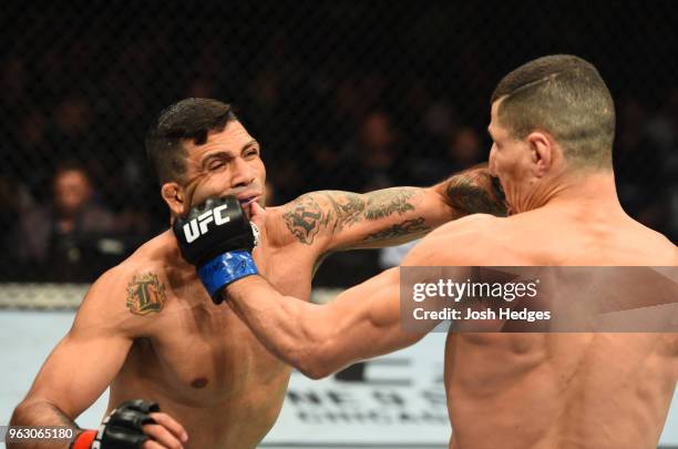 Nordine Taleb of France punches Claudio Silva of Brazil in their welterweight bout during the UFC Fight Night event at ECHO Arena on May 27, 2018 in...