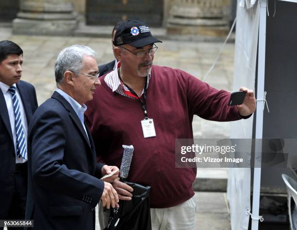 Former President of Colombia Álvaro Uribe Vélez poses for a selfie with a supporter in the polling station during the 2018 Presidential Elections in...