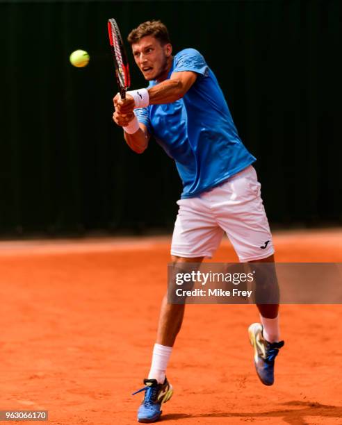 Pablo Carreno Busta of Spain hits a backhand to Jozef Kovalik of Slovakia in the first round of the French Open at Roland Garros on May 27, 2018 in...