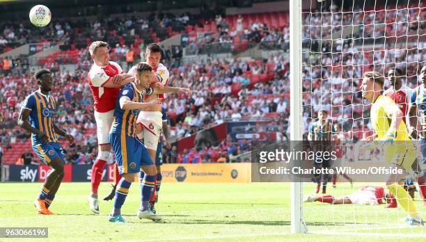 Caolan Lavery of Rotherham, Shrewsbury captain Mat Sadler and Rotherham captain Richard Wood go up for a header in the box during the Sky Bet League...