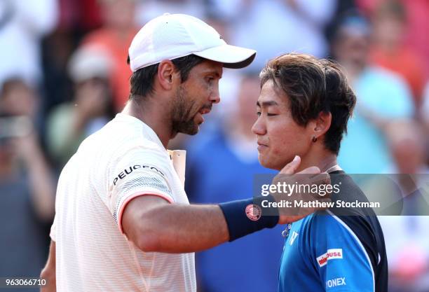 Fernando Verdasco of Spain embraces Yoshihito Nishioka of Japan following victory in the mens singles first round match during day one of the 2018...