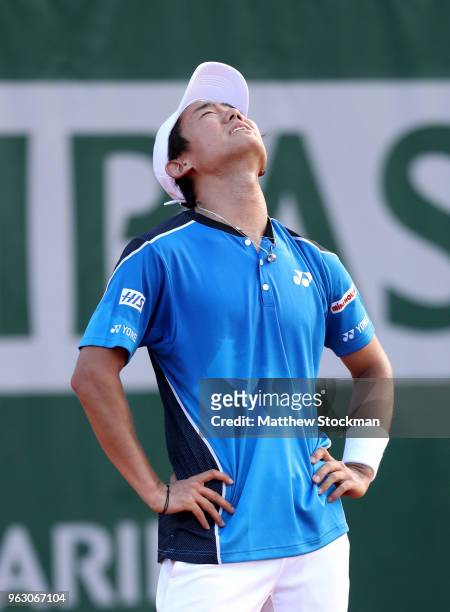 Yoshihito Nishioka of Japan reacts following an injury in the mens singles first round match against Fernando Verdasco of Spain during day one of the...