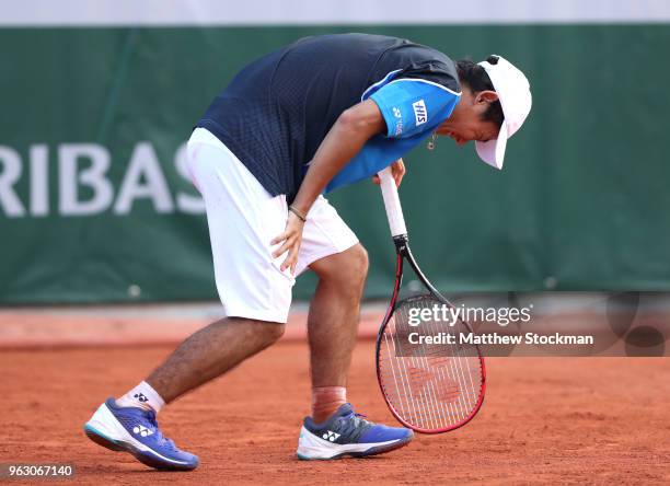 Yoshihito Nishioka of Japan reacts following an injury in the mens singles first round match against Fernando Verdasco of Spain during day one of the...