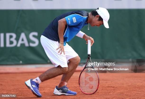 Yoshihito Nishioka of Japan reacts following an injury in the mens singles first round match against Fernando Verdasco of Spain during day one of the...