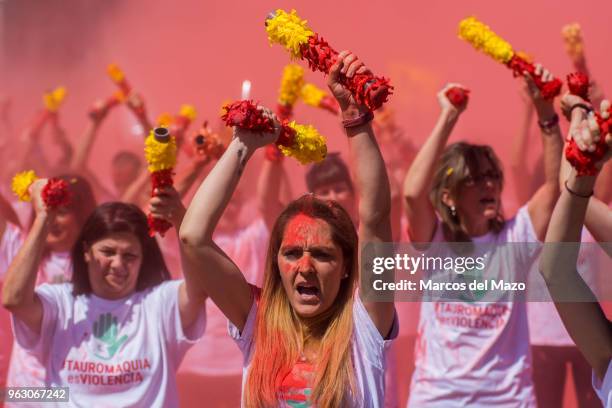 Anti-bullfighting protesters throw red powder representing bull«s blood during a demonstration under the slogan 'Bullfighting is Violence' demanding...