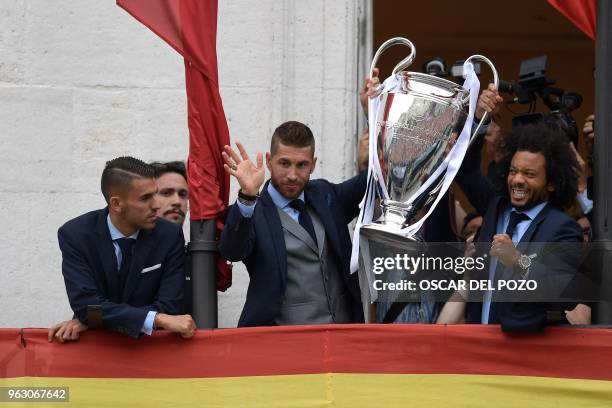 Real Madrid's Brazilian defender Marcelo and Real Madrid's Spanish defender Sergio Ramos hold the trophy next to Real Madrid's Spanish midfielder...