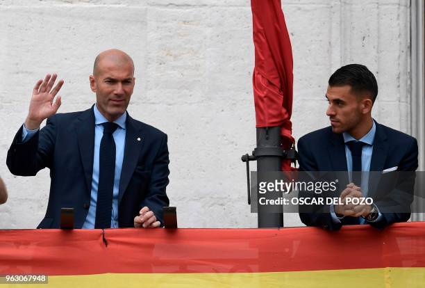 Real Madrid's French coach Zinedine Zidane and Real Madrid's Spanish midfielder Daniel Ceballos greet supporters from the balcony of the headquarters...