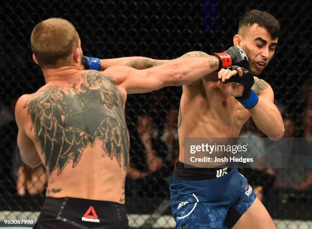 Jason Knight punches Makwan Amirkhani of Kurdistan in their featherweight bout during the UFC Fight Night event at ECHO Arena on May 27, 2018 in...