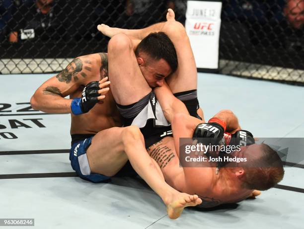 Jason Knight attempts to submit Makwan Amirkhani of Kurdistanin their featherweight bout during the UFC Fight Night event at ECHO Arena on May 27,...