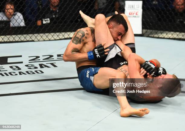 Jason Knight attempts to submit Makwan Amirkhani of Kurdistanin their featherweight bout during the UFC Fight Night event at ECHO Arena on May 27,...