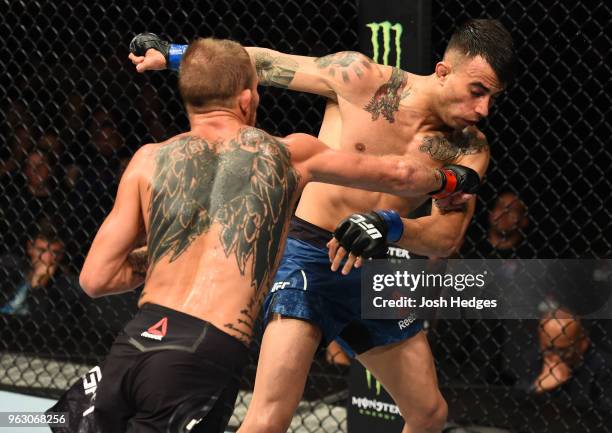 Jason Knight punches Makwan Amirkhani of Kurdistan in their featherweight bout during the UFC Fight Night event at ECHO Arena on May 27, 2018 in...