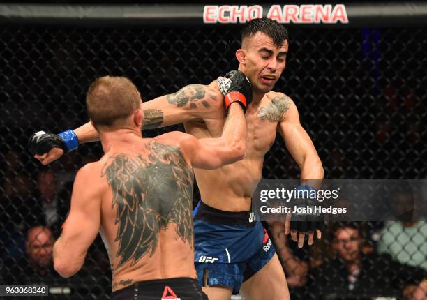 Jason Knight punches Makwan Amirkhani of Kurdistan in their featherweight bout during the UFC Fight Night event at ECHO Arena on May 27, 2018 in...