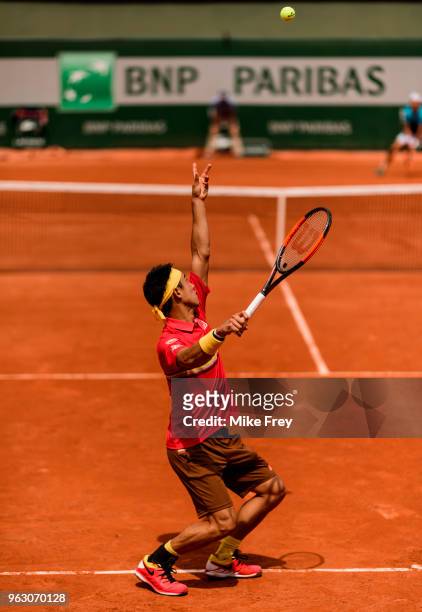Kei Nishikori of Japan serves to Maxime Janvier of France in the first round of the French Open at Roland Garros on May 27, 2018 in Paris, France.