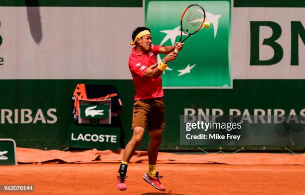 Kei Nishikori of Japan hits a backhand to Maxime Janvier of France in the first round of the French Open at Roland Garros on May 27, 2018 in Paris,...