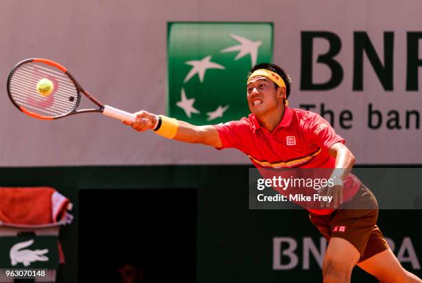 Kei Nishikori of Japan hits a forehand to Maxime Janvier of France in the first round of the French Open at Roland Garros on May 27, 2018 in Paris,...