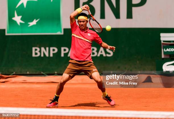 Kei Nishikori of Japan hits a forehand to Maxime Janvier of France in the first round of the French Open at Roland Garros on May 27, 2018 in Paris,...