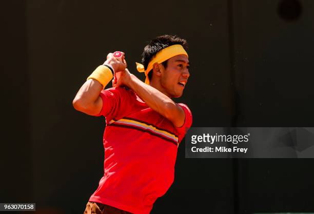 Kei Nishikori of Japan hits a backhand to Maxime Janvier of France in the first round of the French Open at Roland Garros on May 27, 2018 in Paris,...