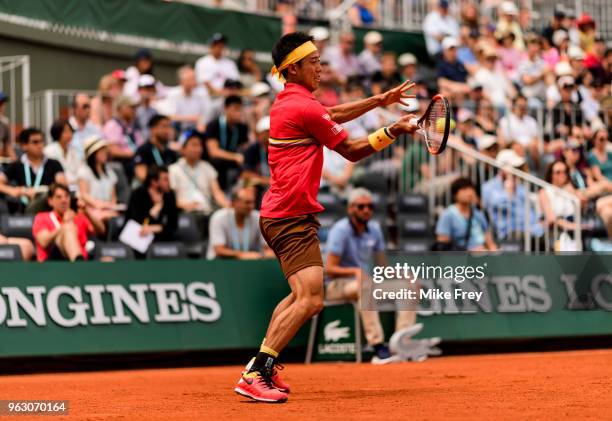 Kei Nishikori of Japan hits a forehand to Maxime Janvier of France in the first round of the French Open at Roland Garros on May 27, 2018 in Paris,...