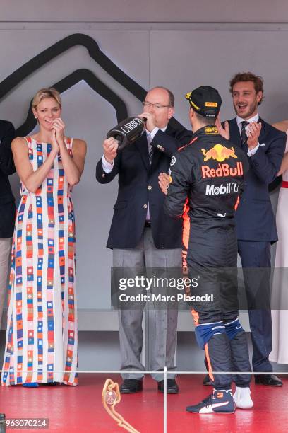 Race winner Daniel Ricciardo of Australia and Red Bull Racing shares his champagne with Prince Albert of Monaco and Princess Charlene of Monaco on...