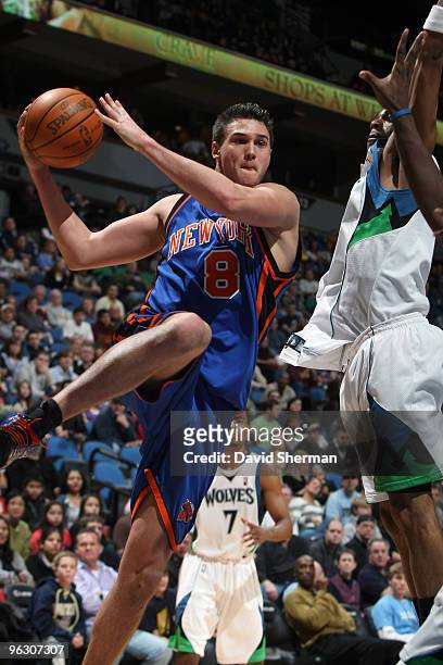 Mario Gallinari of the New York Knicks passes against Wayne Ellington of the Minnesota Timberwolves during the game on January 31, 2010 at the Target...