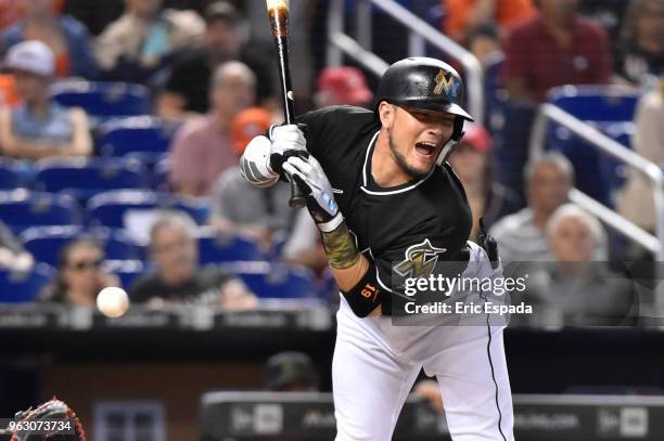 Miguel Rojas of the Miami Marlins reacts after getting hit by a pitch during the second inning against the Washington Nationals at Marlins Park on...