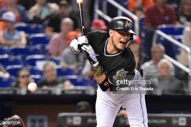 Miguel Rojas of the Miami Marlins reacts after getting hit by a pitch during the second inning against the Washington Nationals at Marlins Park on...