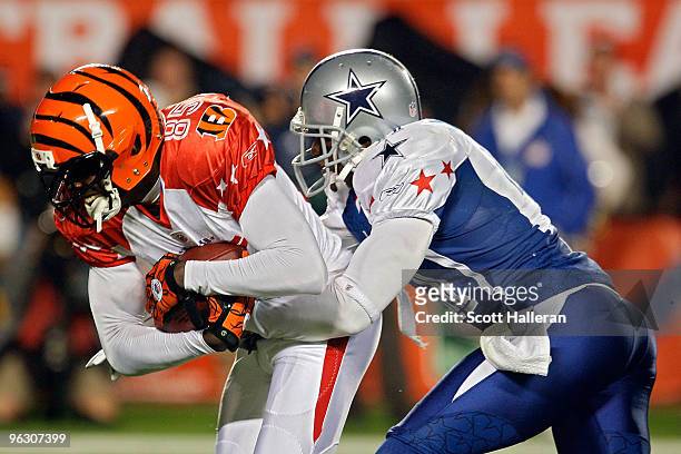 Terence Newman of the Dallas Cowboys tackles Chad Ochocinco of the Cincinnati Bengals during the 2010 AFC-NFC Pro Bowl at Sun Life Stadium on January...