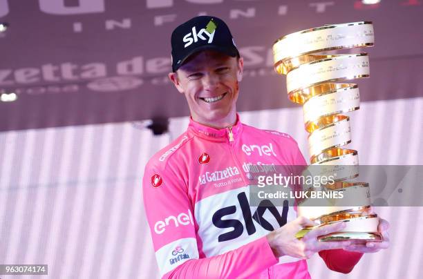 Pink jersey Britain's rider of team Sky Christopher Froome, winner, poses with the trophy on the podium after the 21st and last stage of the 101st...