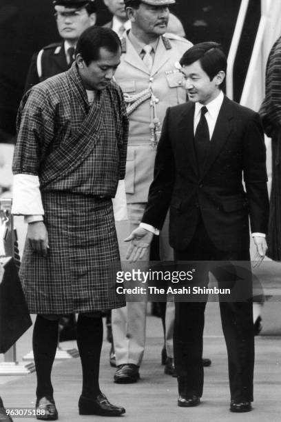 King Jigme Singye Wangchuck of Bhutan is welcomed by Crown Prince Naruhito on arrival ahead of the Funeral of late Emperor Hirohito at Haneda Airport...