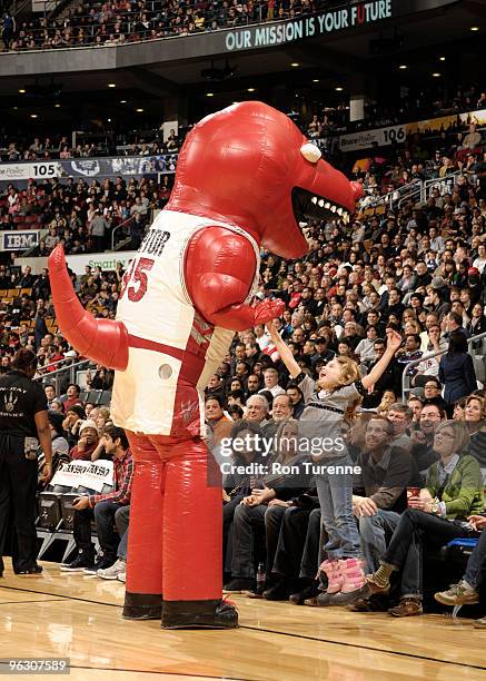 An inflated Raptor entertains the crowd and gives a young fan a high five during a timeout in a game against the Indiana Pacers on January 31, 2010...