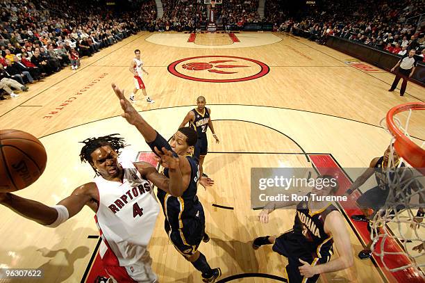 Chris Bosh of the Toronto Raptors drives the paint and tries the hookshot over Danny Granger of the Indiana Pacers during a game on January 31, 2010...