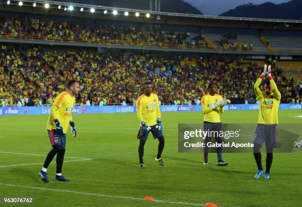 David Ospina, Jose Cuadrado, Camilo Vargas, goalkeepers of Colombia team greet to the fans during a training session open to the public as part of...