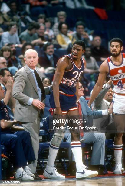 Head coach Red Holzman of the New York Knicks as his player Micheal Ray Richardson reacts against the Washington Bullets during an NBA basketball...