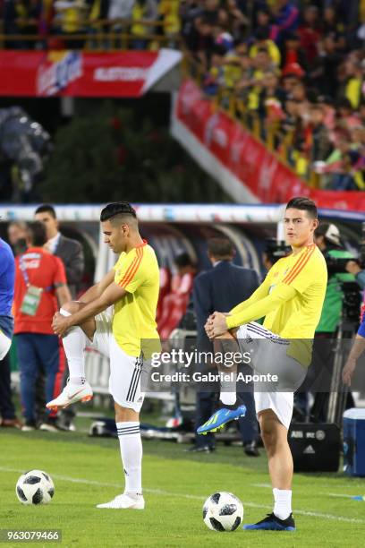 Falcao Garcia and James Rodriguez of Colombia stretch during a training session open to the public as part of the preparation for FIFA World Cup...
