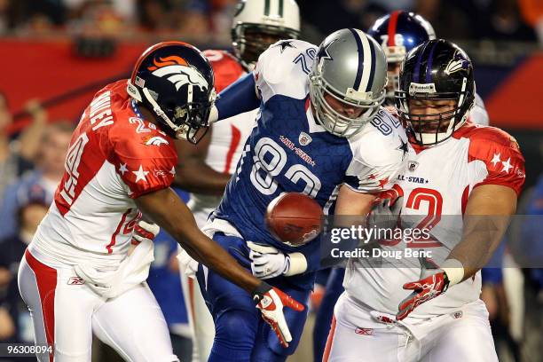 Champ Bailey of the Denver Broncos attempts to lateral the ball to teammates Haloti Ngata of the Baltimore Ravens around Jason Witten of the Dallas...