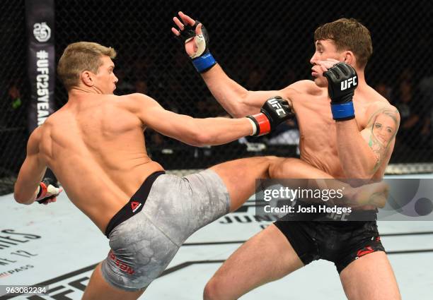 Stephen Thompson kicks Darren Till of England in their welterweight bout during the UFC Fight Night event at ECHO Arena on May 27, 2018 in Liverpool,...