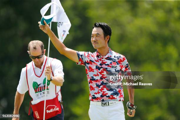 Kevin Na waves to the crowd after a birdie putt on on the 18th green tying the course record with a 61 during the final round of the Fort Worth...