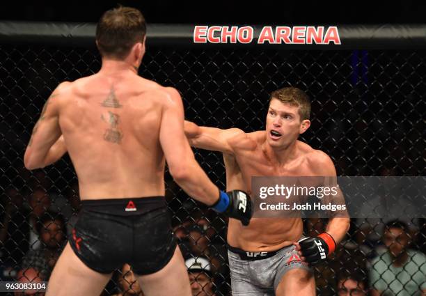 Stephen Thompson punches Darren Till of England in their welterweight bout during the UFC Fight Night event at ECHO Arena on May 27, 2018 in...