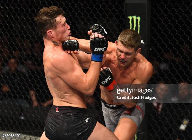 Stephen Thompson punches Darren Till of England in their welterweight bout during the UFC Fight Night event at ECHO Arena on May 27, 2018 in...