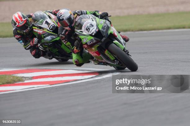 Toprak Razgatlioglu of Turkey and Kawasaki Puccetti Racing leads Jonathan Rea of Great Britain and KAWASAKI RACING TEAM WorldSBK during the Superbike...