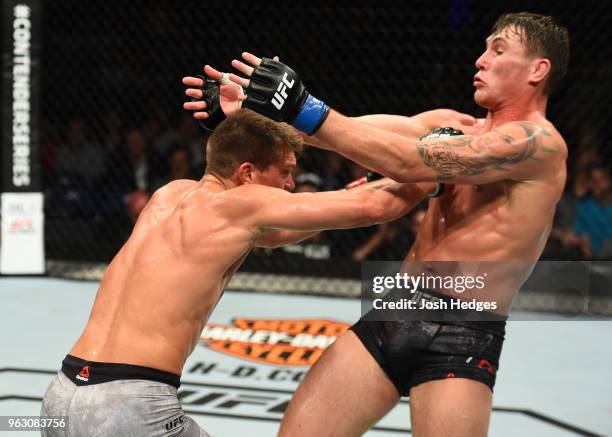 Stephen Thompson punches Darren Till of England in their welterweight bout during the UFC Fight Night event at ECHO Arena on May 27, 2018 in...