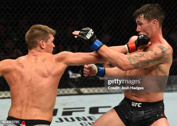 Stephen Thompson punches Darren Till of England in their welterweight bout during the UFC Fight Night event at ECHO Arena on May 27, 2018 in...