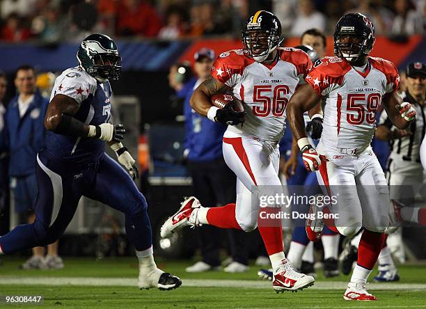 LaMarr Woodley of the Pittsburgh Steelers runs with the ball after making an interception during the 2010 AFC-NFC Pro Bowl at Sun Life Stadium on...