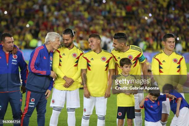 Jose Pekerman, coach of Colombia talks to Colombian singer Maluma during a training session open to the public as part of the preparation for FIFA...