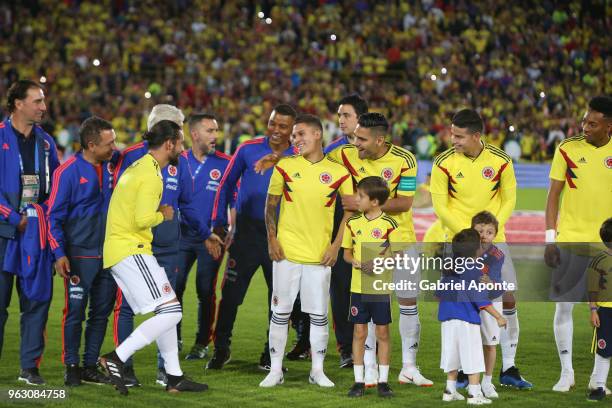 Colombian singer Maluma greets Juan Quintero, Falcao Garcia and James Rodriguez of Colombia during a training session open to the public as part of...